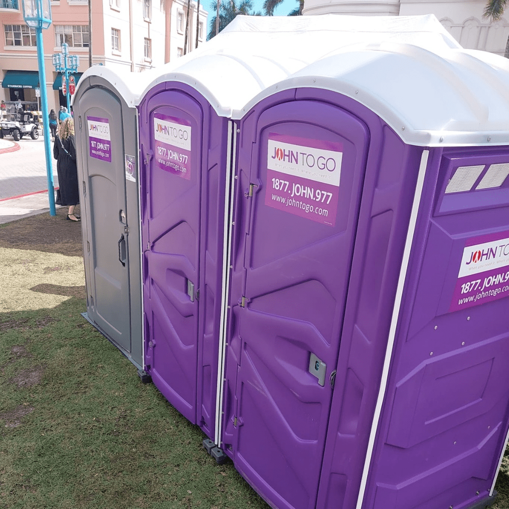 John To Go’s portable toilets at an outdoor event John To Go’s portable toilets at an outdoor event