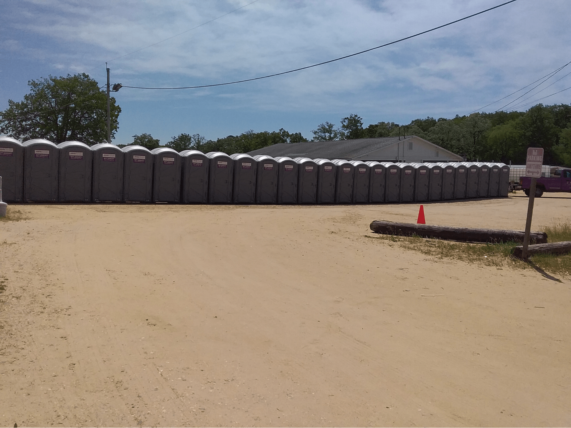a slew of temporary portable toilets at a construction site a slew of temporary portable toilets at a construction site
