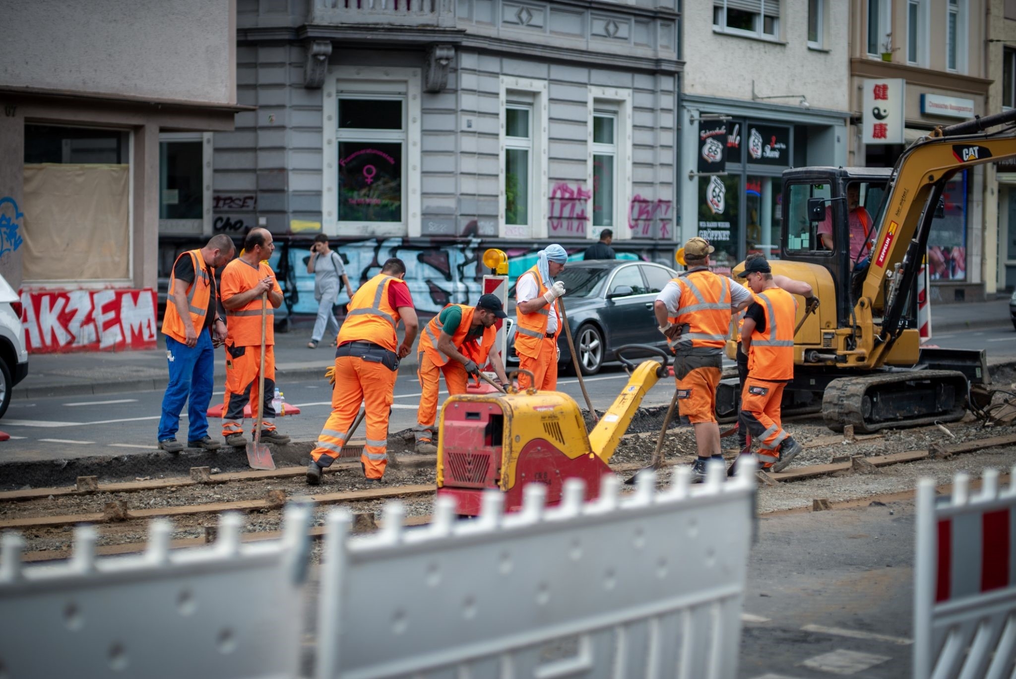 Construction workers and a tractor working on a railroad