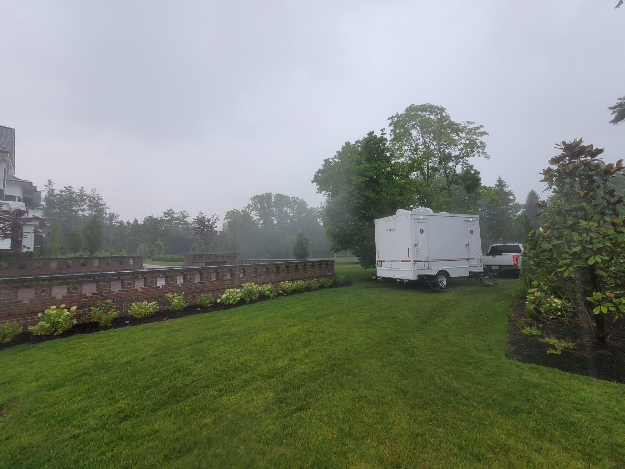 Mobile restroom trailer parked on grass