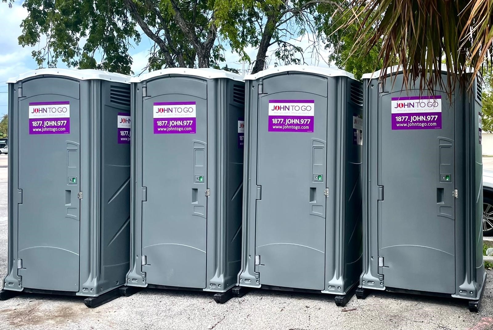 row of portable outdoor bathrooms