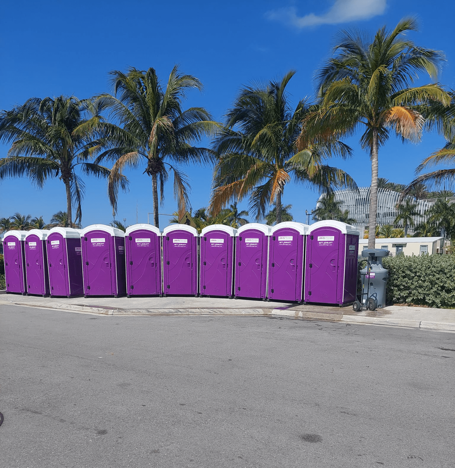 row of purple porta johns and handwashing sink in Florida