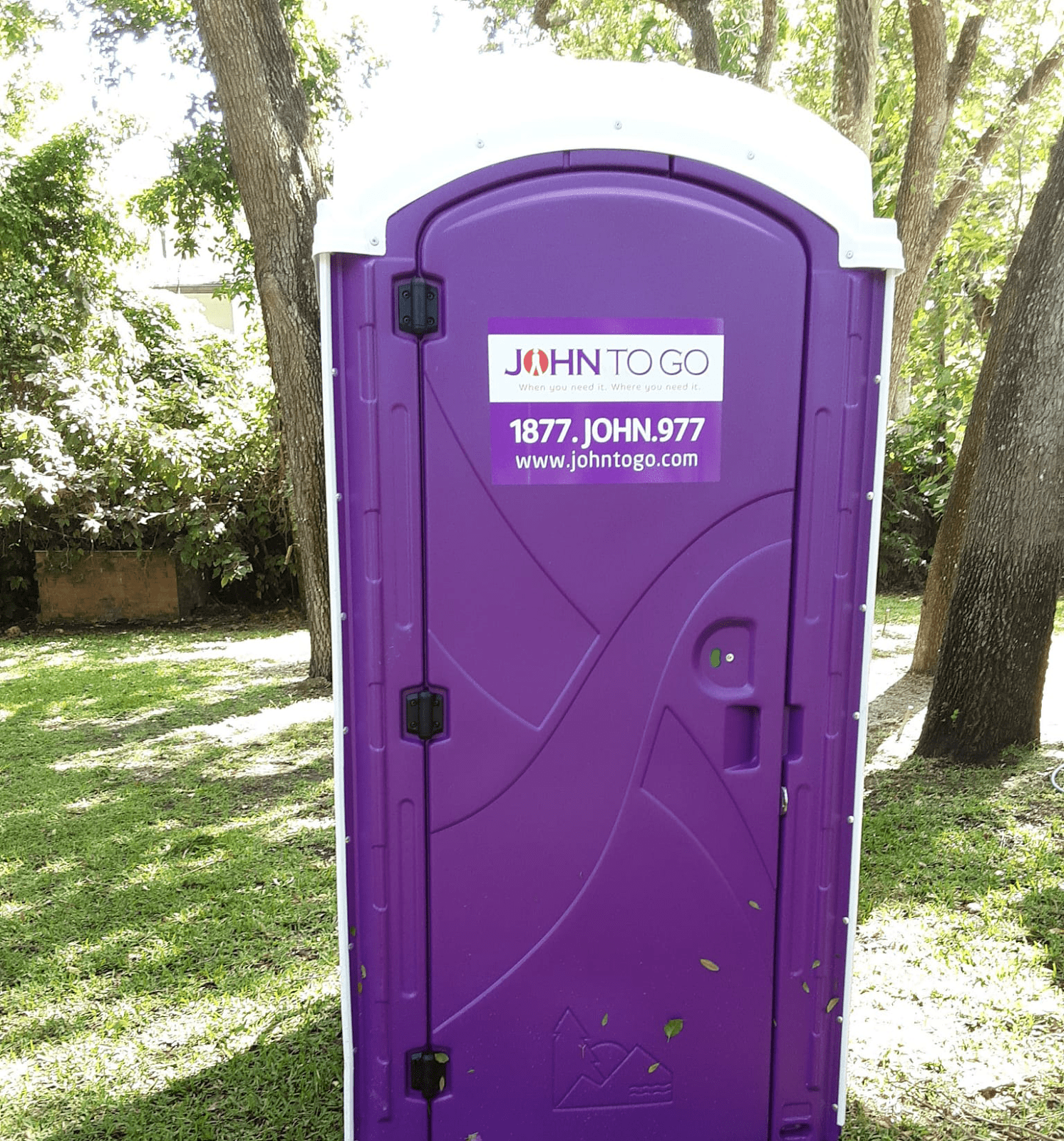 porta potty in grassy area