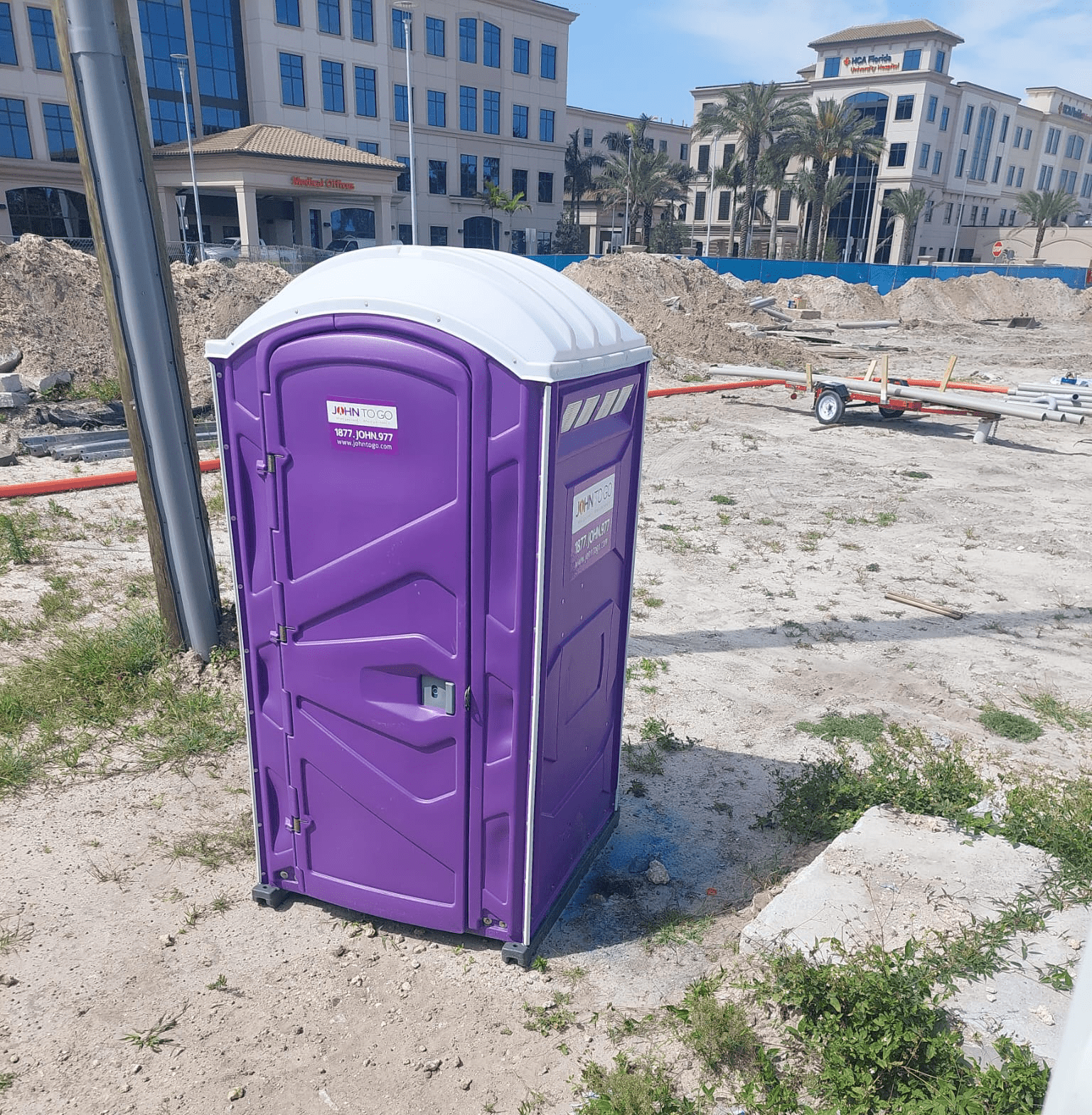Purple porta john rental at construction site