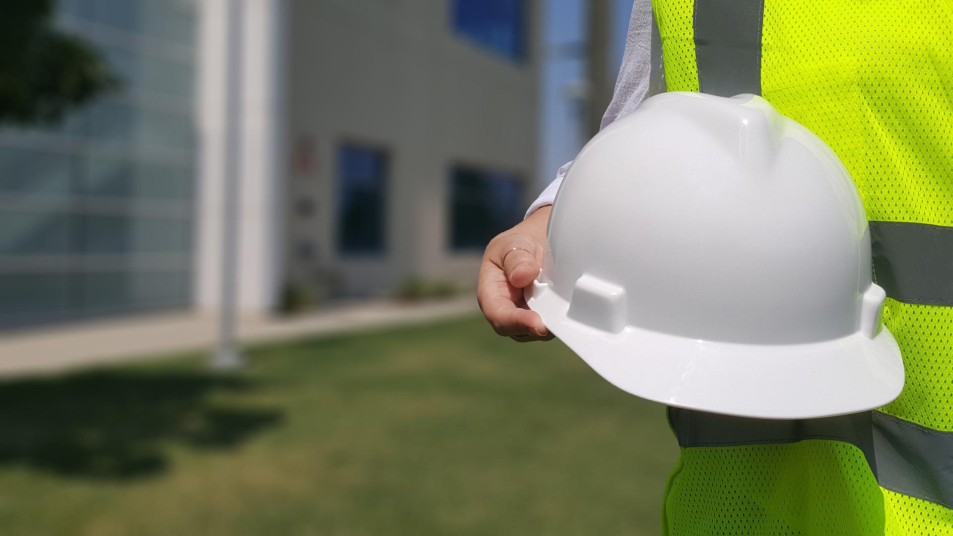 construction worker holding hat