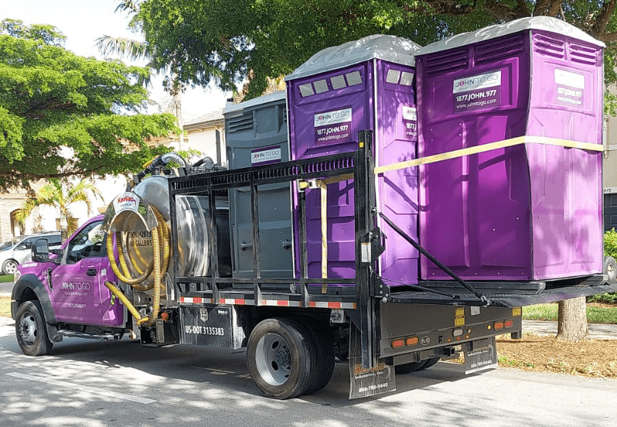 truck carrying portable toilets