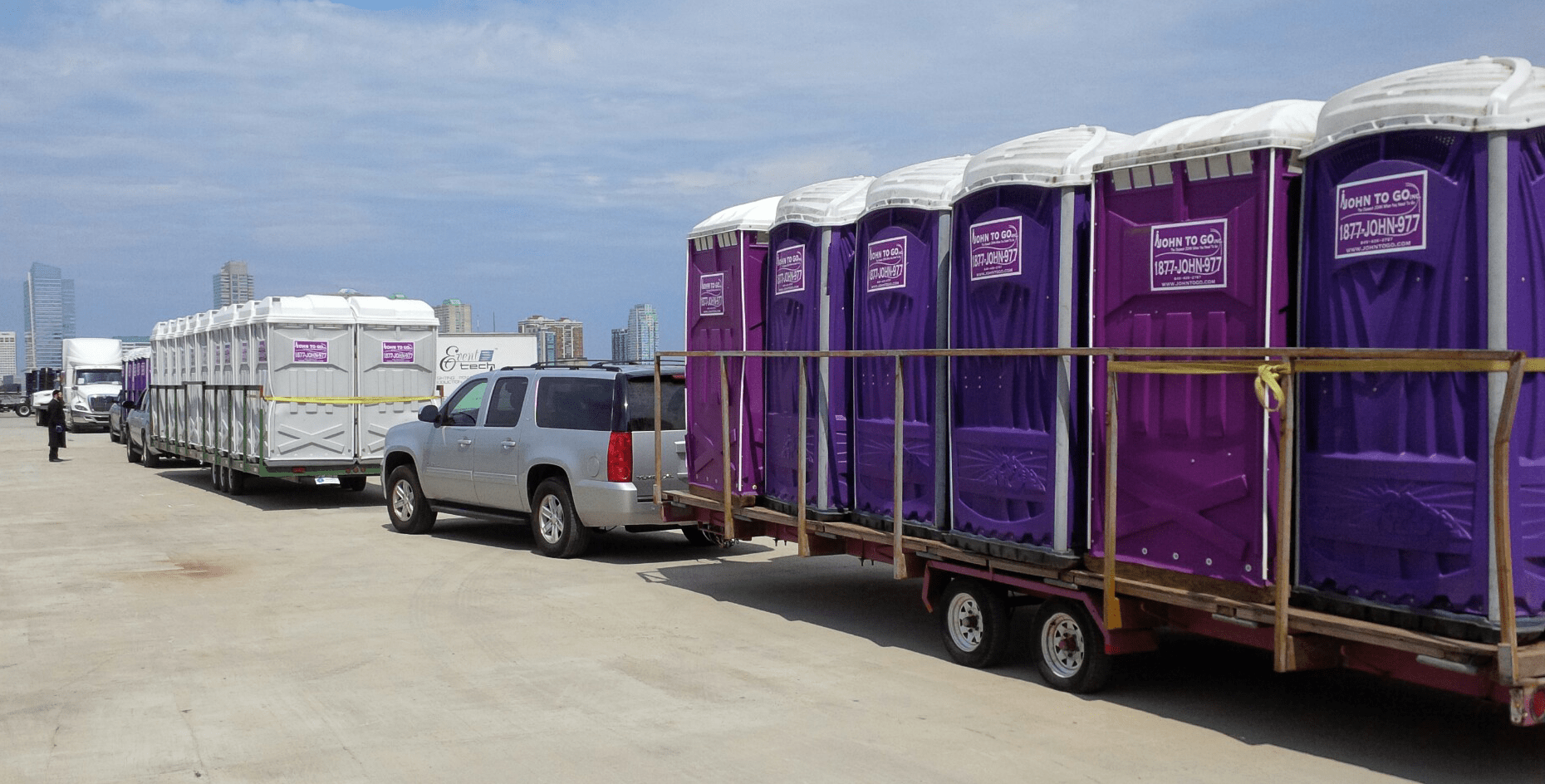 trucks carrying porta potties