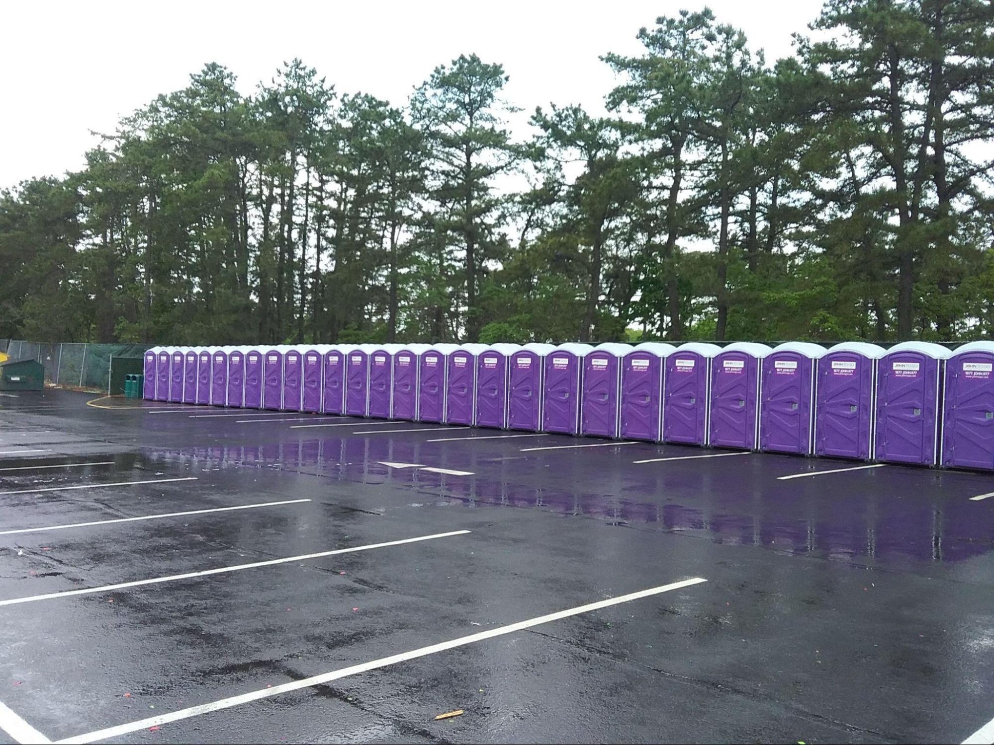 lineup of dozens of portable toilet rentals