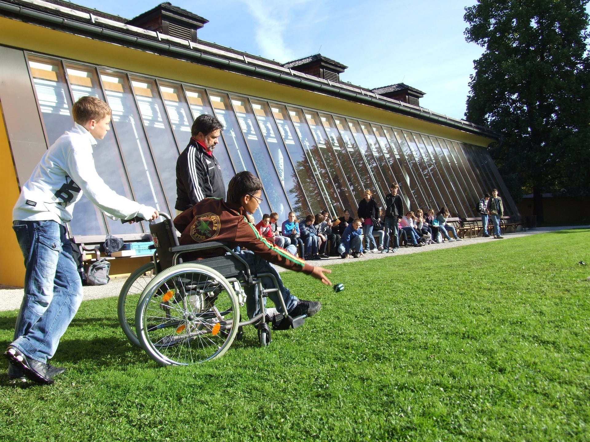 child in wheelchair participating in inclusive event
