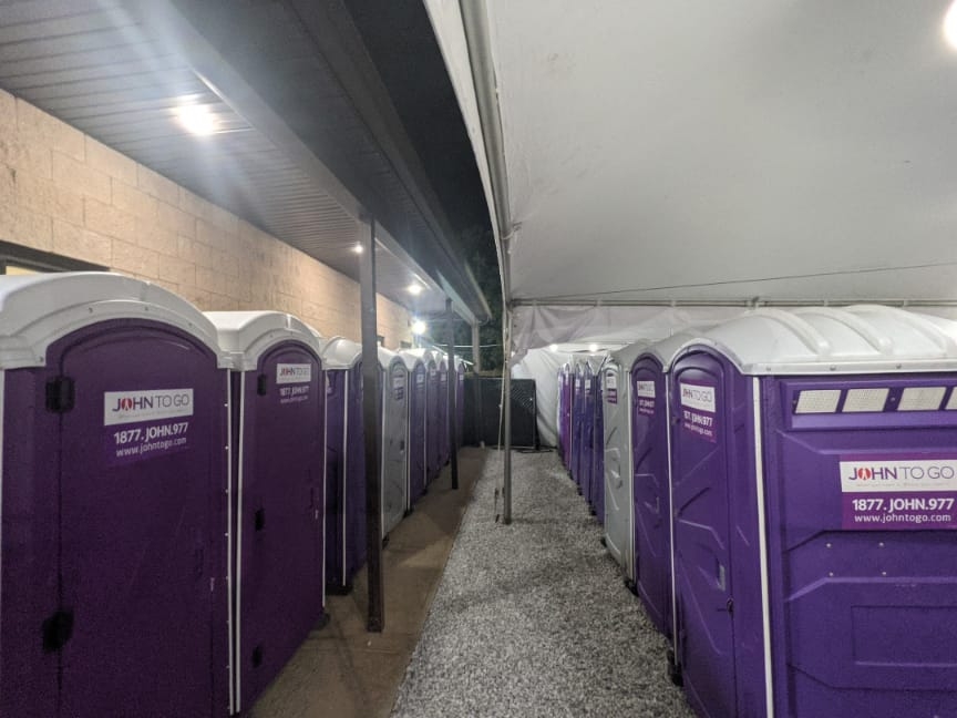 setup of portable restroom units in tent