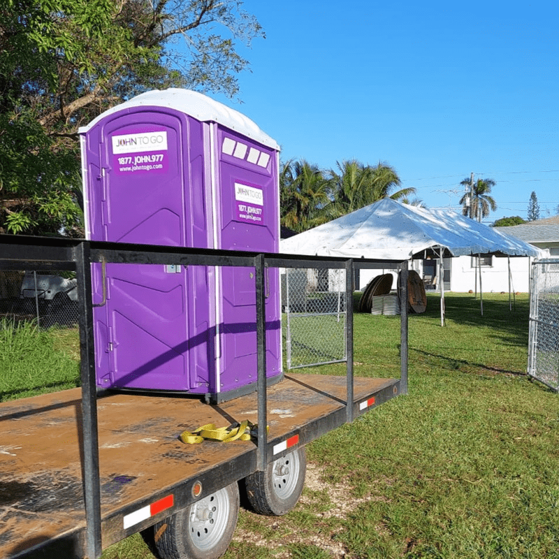 Portable toilet being transported to an outdoor event