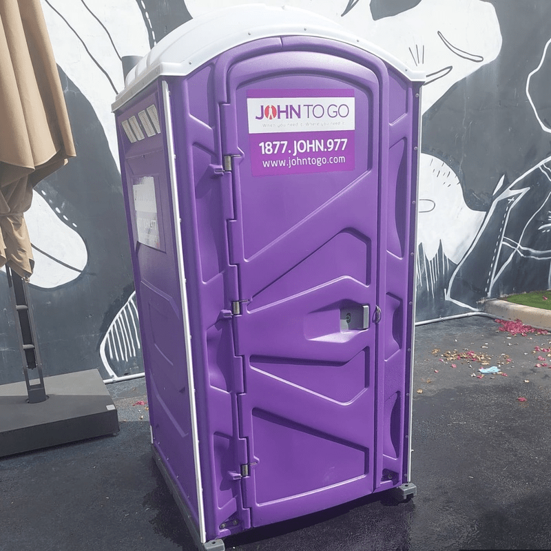 Porta potty strategically positioned at an outdoor event
