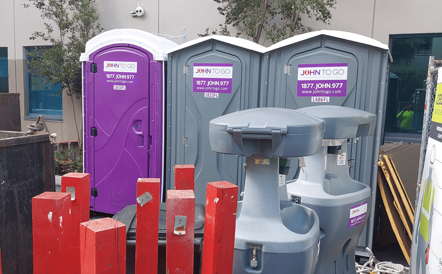 Portable hand washing station between porta potties at outdoor event