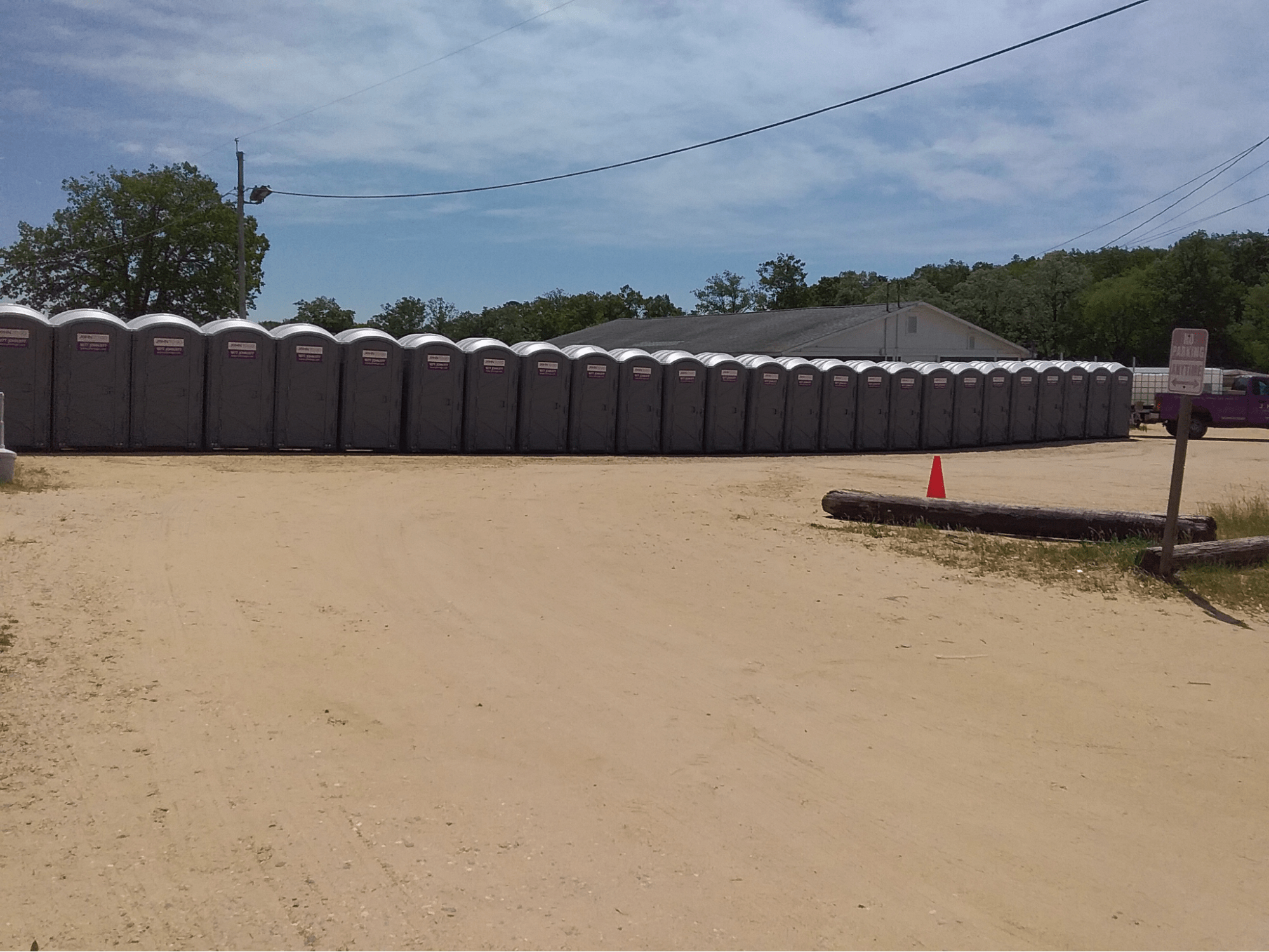 a slew of temporary portable toilets at a construction site