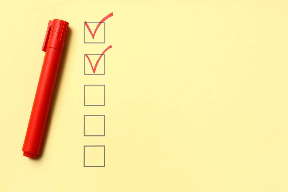 checkboxes with a red pen on a yellow background