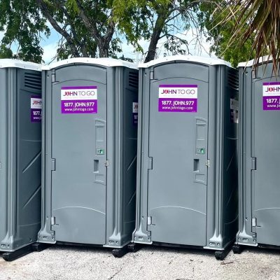 row of portable outdoor bathrooms